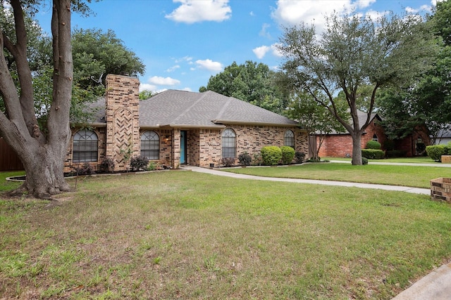 1112 Indian Ridge Dr, Denton, TX 76205 - view of front of property with a chimney, a front lawn, roof with shingles, and brick siding