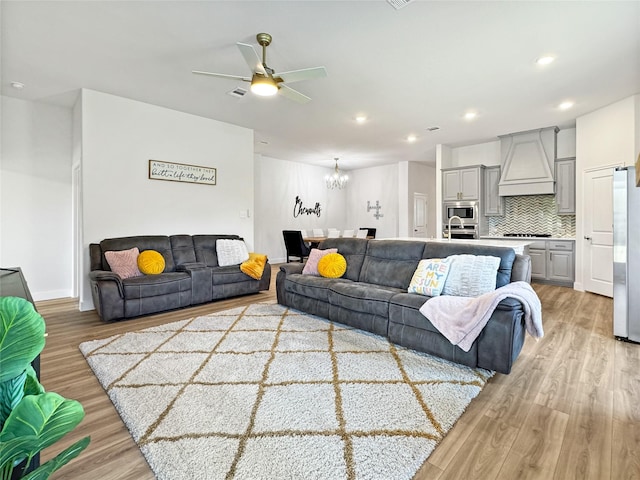 3978 Sidney Ln, Heath, TX 75126 - living area with light wood finished floors, a chandelier, ceiling fan, and recessed lighting