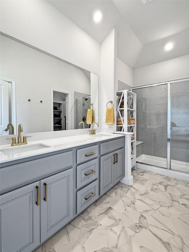 3978 Sidney Ln, Heath, TX 75126 - full bathroom featuring double vanity, a stall shower, a walk in closet, marble finish floors, and vaulted ceiling