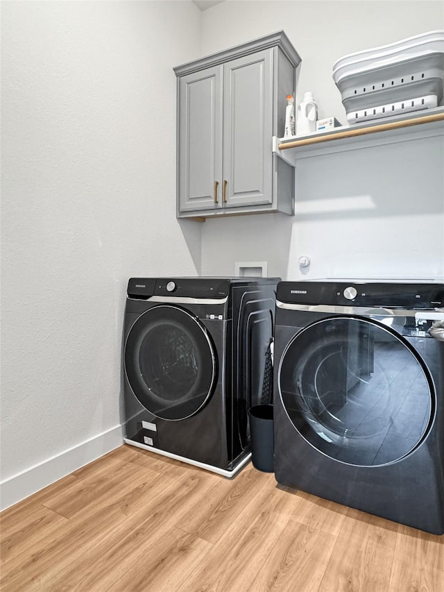 3978 Sidney Ln, Heath, TX 75126 - washroom with washer and dryer, cabinet space, and light wood-style flooring