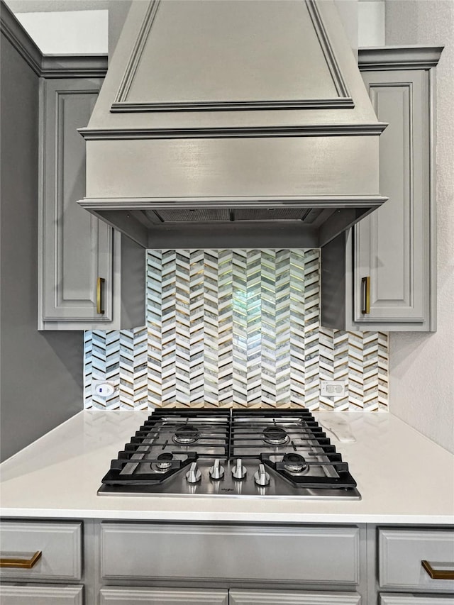 3978 Sidney Ln, Heath, TX 75126 - kitchen featuring gray cabinetry, stainless steel gas cooktop, tasteful backsplash, and light countertops