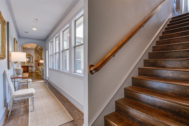 4139 Herschel Ave, Dallas, TX 75219 - stairs featuring arched walkways, healthy amount of natural light, ornamental molding, and wood finished floors
