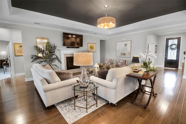 717 Freedom Ln, Aubrey, TX 76227 - living area featuring a tray ceiling, dark wood finished floors, a fireplace, and crown molding