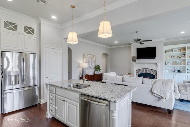 1101 Cypress Creek Cir, Shreveport, LA 71106 - kitchen with stainless steel appliances, arched walkways, dark wood finished floors, ceiling fan, and a fireplace