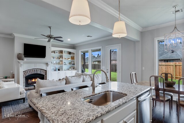 1101 Cypress Creek Cir, Shreveport, LA 71106 - kitchen featuring stainless steel dishwasher, dark wood-type flooring, open floor plan, a fireplace, and ornamental molding