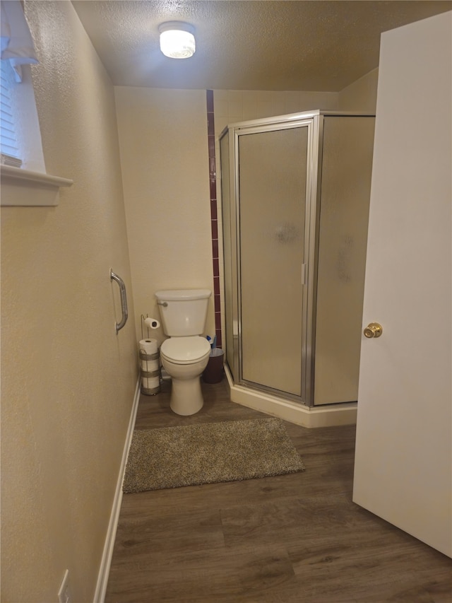 91 Heather Ln, Pottsboro, TX 75076 - bathroom featuring wood finished floors, a stall shower, and a textured ceiling