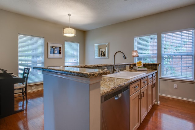 18423 Rain Dance Trl, Dallas, TX 75252 - kitchen featuring stainless steel dishwasher, dark wood-type flooring, a kitchen island with sink, pendant lighting, and dark stone countertops