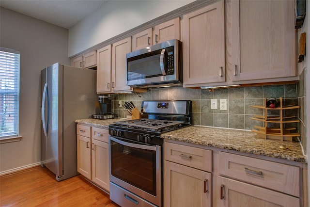 18423 Rain Dance Trl, Dallas, TX 75252 - kitchen with stainless steel appliances, light brown cabinets, and decorative backsplash