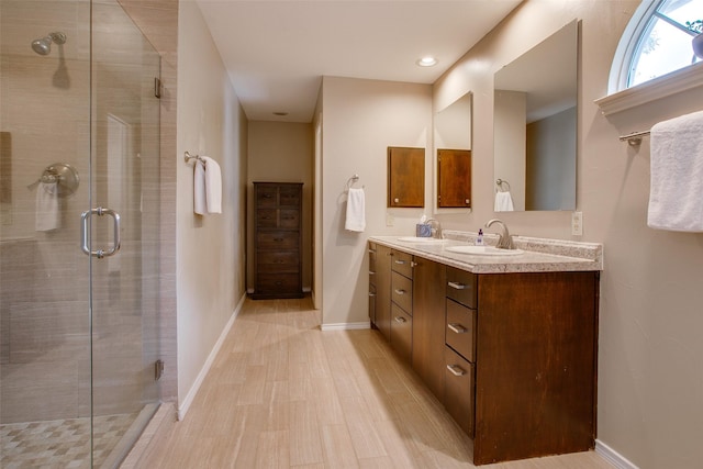 18423 Rain Dance Trl, Dallas, TX 75252 - bathroom with double vanity, a stall shower, and wood finished floors