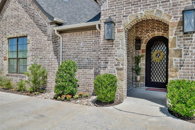 1001 Quarry Ct, Granbury, TX 76048 - property entrance with brick siding and roof with shingles