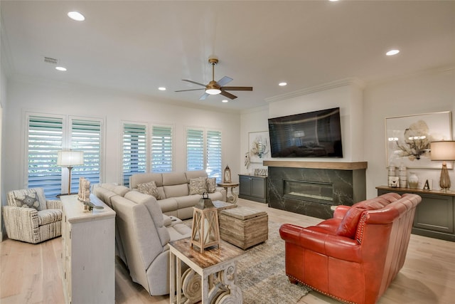 1001 Quarry Ct, Granbury, TX 76048 - living area with ceiling fan, ornamental molding, a premium fireplace, light wood finished floors, and recessed lighting
