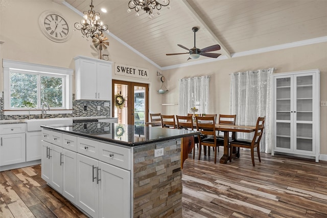 139 County Road 376, Lott, TX 76656 - kitchen with dark wood-style floors, plenty of natural light, backsplash, a kitchen island, and a wooden ceiling with exposed beams