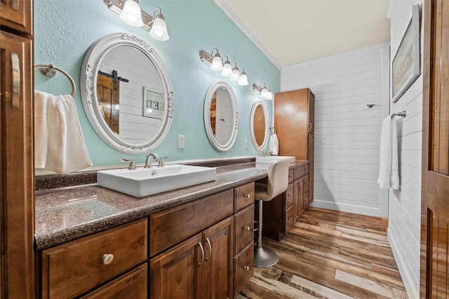 139 County Road 376, Lott, TX 76656 - full bathroom with vanity, wood finished floors, wood walls, and crown molding