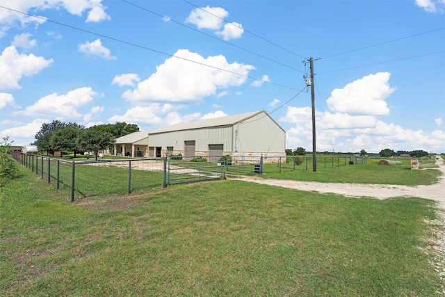 139 County Road 376, Lott, TX 76656 - view of yard featuring a pole building, an outdoor structure, a detached garage, and a view of countryside