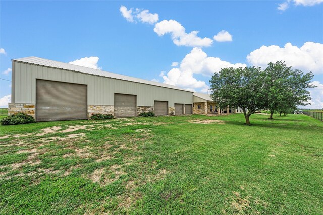 139 County Road 376, Lott, TX 76656 - view of grassy yard featuring a detached garage and an outbuilding