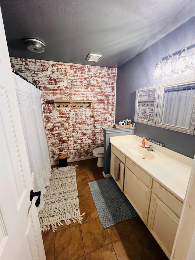 1507 Bridge Water Ln, Mansfield, TX 76063 - bathroom featuring tile patterned floors, vanity, brick wall, a textured ceiling, and curtained shower