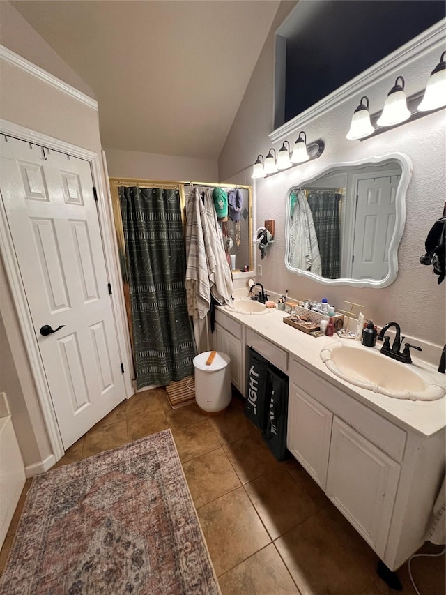 1507 Bridge Water Ln, Mansfield, TX 76063 - bathroom featuring vaulted ceiling, double vanity, tile patterned floors, and a shower with curtain