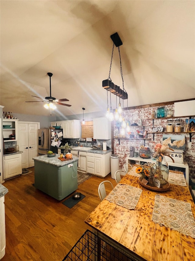 1507 Bridge Water Ln, Mansfield, TX 76063 - kitchen featuring stainless steel fridge with ice dispenser, white cabinetry, dark wood finished floors, a ceiling fan, and vaulted ceiling