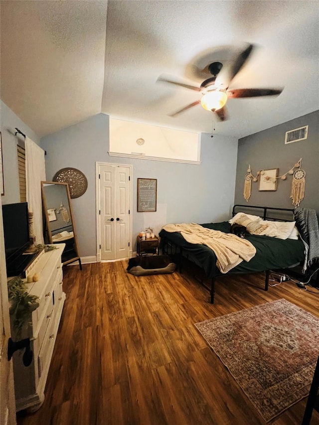 1507 Bridge Water Ln, Mansfield, TX 76063 - bedroom with dark wood-type flooring, vaulted ceiling, ceiling fan, and a textured ceiling