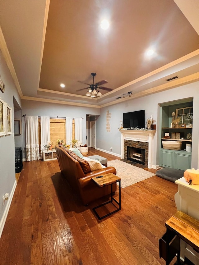 1507 Bridge Water Ln, Mansfield, TX 76063 - living room with a tray ceiling, ornamental molding, dark wood-style floors, a fireplace, and ceiling fan