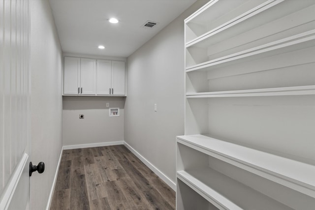 1007 Monte Carlo Dr, Grand Saline, TX 75140 - washroom featuring hookup for an electric dryer, cabinet space, dark wood finished floors, hookup for a washing machine, and recessed lighting