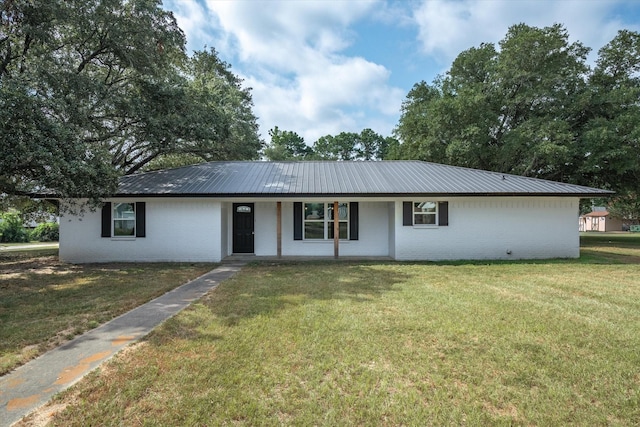 1007 Monte Carlo Dr, Grand Saline, TX 75140 - ranch-style house featuring brick siding, a front yard, a metal roof, and covered porch