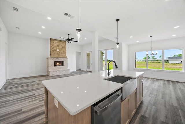 5150 Fox Trot Ln, Caddo Mills, TX 75135 - kitchen featuring stainless steel dishwasher, wood finished floors, a ceiling fan, a brick fireplace, and recessed lighting