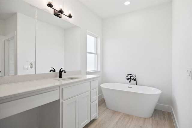 5150 Fox Trot Ln, Caddo Mills, TX 75135 - bathroom featuring a freestanding bath, vanity, wood finished floors, and recessed lighting