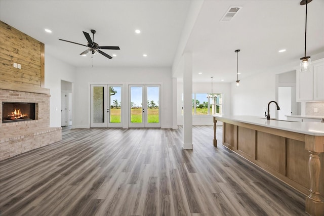 5150 Fox Trot Ln, Caddo Mills, TX 75135 - unfurnished living room featuring recessed lighting, ceiling fan, a brick fireplace, and wood finished floors