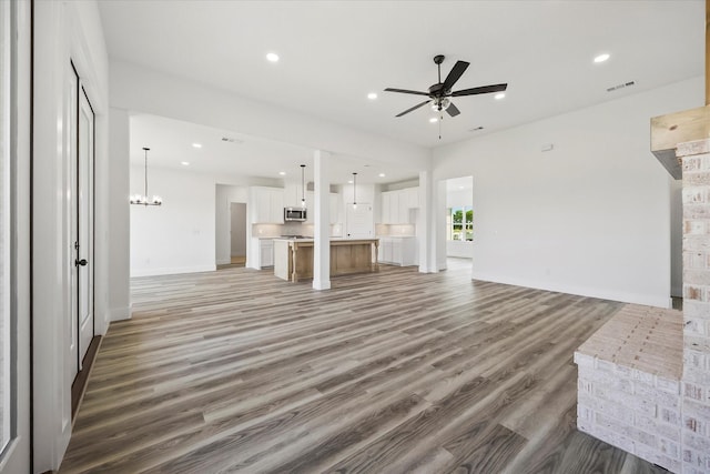 5150 Fox Trot Ln, Caddo Mills, TX 75135 - unfurnished living room featuring ceiling fan, light wood-type flooring, recessed lighting, and a chandelier