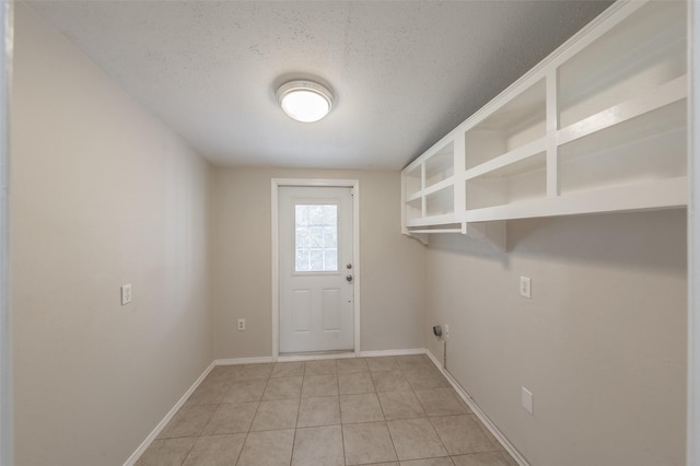5105 French Wood Dr, Arlington, TX 76016 - laundry area with a textured ceiling, light tile patterned flooring, and hookup for an electric dryer