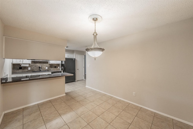 5105 French Wood Dr, Arlington, TX 76016 - kitchen with black appliances, white cabinets, a peninsula, decorative backsplash, and dark countertops