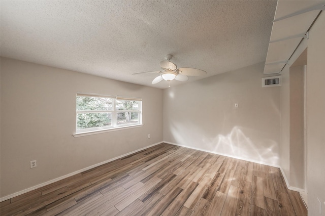 5105 French Wood Dr, Arlington, TX 76016 - unfurnished room featuring wood finished floors, a textured ceiling, and ceiling fan