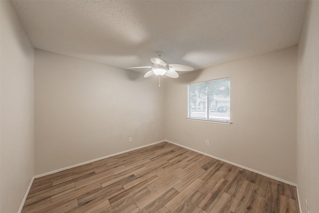 5105 French Wood Dr, Arlington, TX 76016 - empty room with wood finished floors, ceiling fan, and a textured ceiling