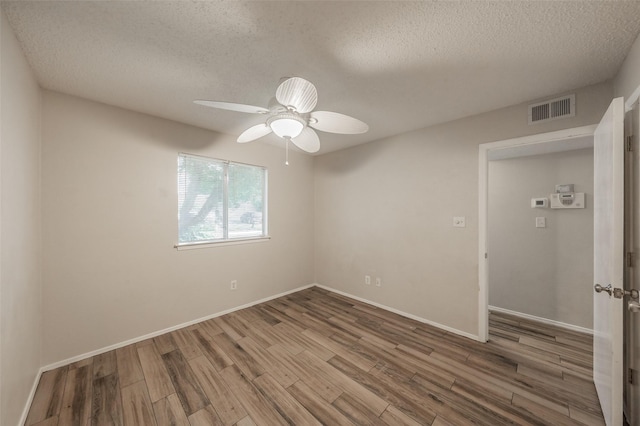 5105 French Wood Dr, Arlington, TX 76016 - empty room with a textured ceiling, wood finished floors, and a ceiling fan