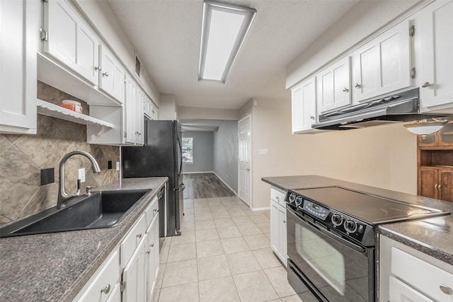 5105 French Wood Dr, Arlington, TX 76016 - kitchen featuring black electric range, under cabinet range hood, dark countertops, and white cabinetry