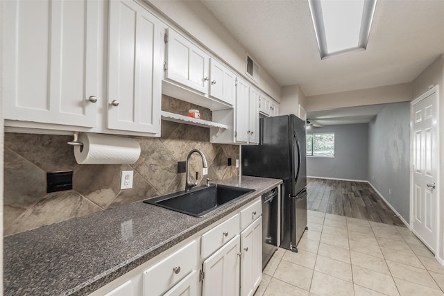 5105 French Wood Dr, Arlington, TX 76016 - kitchen featuring black appliances, white cabinets, tasteful backsplash, and light tile patterned floors