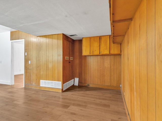 422 11th St, Grand Prairie, TX 75051 - empty room with wood walls and light wood-type flooring