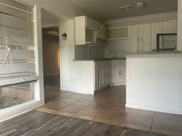 1814 E Belt Line Rd, Carrollton, TX 75006 - kitchen featuring crown molding, white cabinets, and tile patterned floors