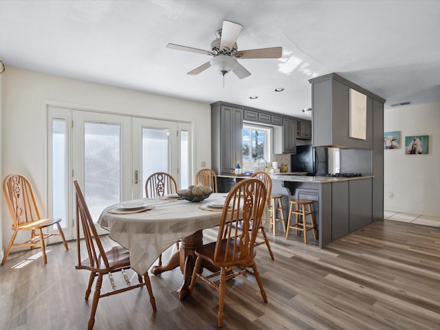 3207 Lynnwood Dr, Arlington, TX 76013 - dining area with french doors, light wood finished floors, and a ceiling fan
