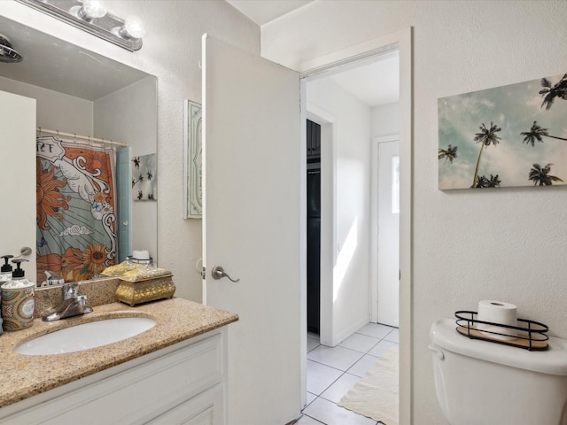 3207 Lynnwood Dr, Arlington, TX 76013 - full bathroom with vanity, tile patterned floors, and a textured wall
