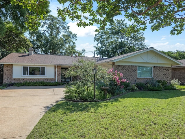 3207 Lynnwood Dr, Arlington, TX 76013 - ranch-style house with brick siding, a front yard, driveway, and a chimney