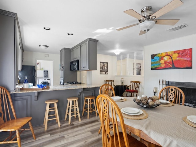 3207 Lynnwood Dr, Arlington, TX 76013 - dining room with washer / dryer, light wood-style floors, and a ceiling fan