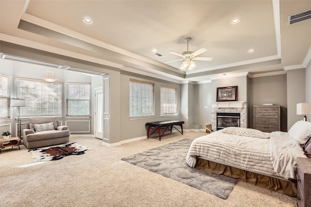 114 Mischief Ln, Rockwall, TX 75032 - bedroom featuring a raised ceiling, light carpet, ornamental molding, a premium fireplace, and recessed lighting