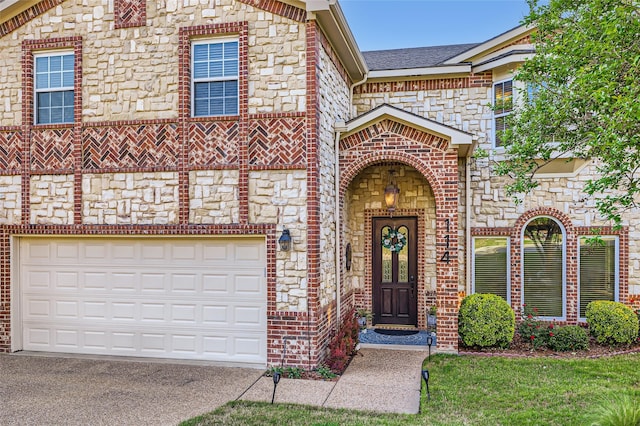 114 Mischief Ln, Rockwall, TX 75032 - doorway to property featuring stone siding, concrete driveway, and brick siding