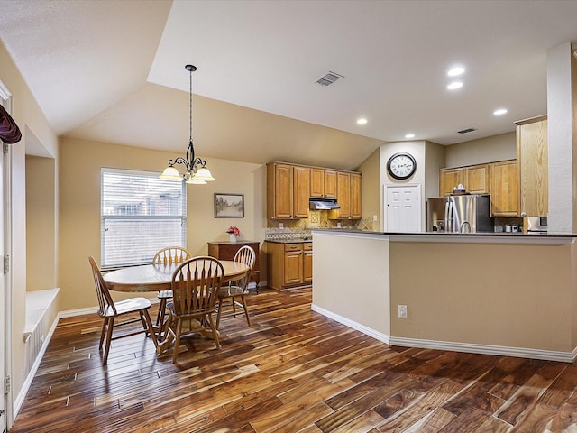 1597 Sweetbriar Dr, Allen, TX 75002 - kitchen with stainless steel fridge, dark wood-style flooring, under cabinet range hood, lofted ceiling, and dark countertops