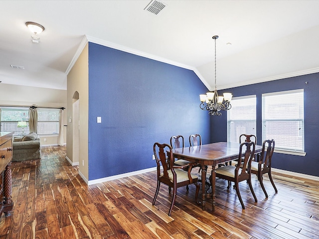 1597 Sweetbriar Dr, Allen, TX 75002 - dining area featuring crown molding, a chandelier, dark wood finished floors, arched walkways, and vaulted ceiling