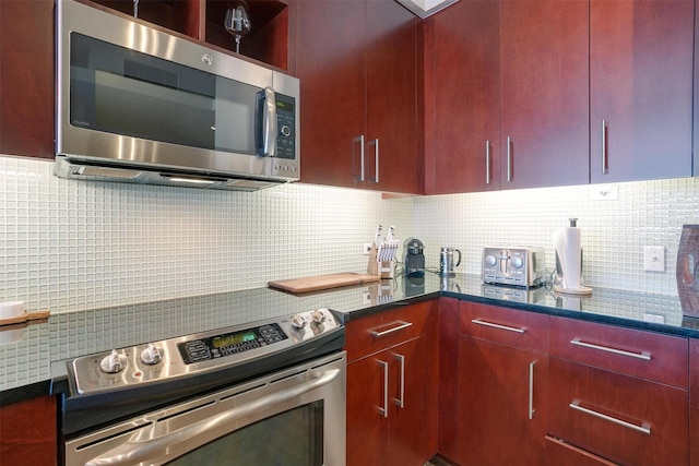 2600 W 7th St Unit 2452, Fort Worth, TX 76107 - kitchen with stainless steel appliances, tasteful backsplash, dark brown cabinets, and dark stone countertops