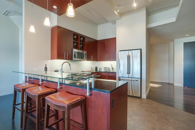 2600 W 7th St Unit 2452, Fort Worth, TX 76107 - kitchen featuring stainless steel appliances, a peninsula, hanging light fixtures, decorative backsplash, and open shelves