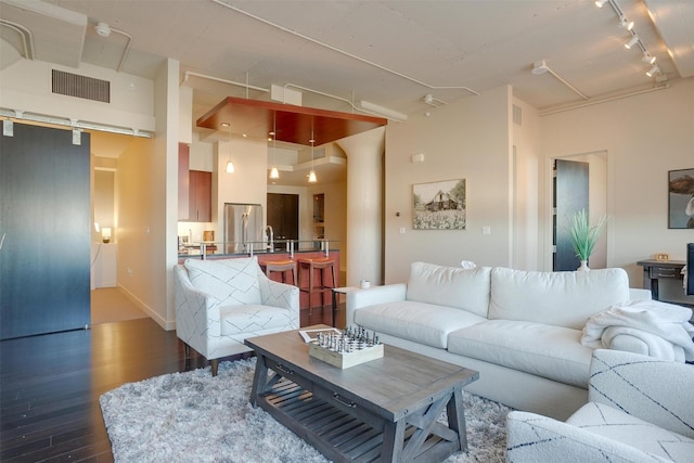 2600 W 7th St Unit 2452, Fort Worth, TX 76107 - living area with dark wood-type flooring, rail lighting, and a high ceiling
